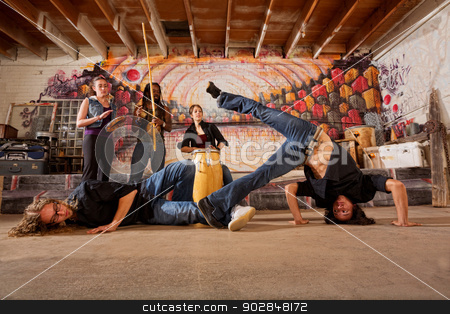 To use this stock image in your creative project, please select the size you need over to the right and click the "Add to Cart" button.
Your downloaded image will come with the Cutcaster watermark removed so don’t worry about the watermark you see on this page. Brazilian Martial Artists Sparring stock photo, Two capoeira practitioners duel in urban building by Scott Griessel