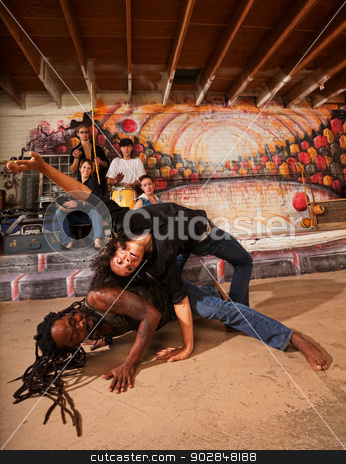 To use this stock image in your creative project, please select the size you need over to the right and click the "Add to Cart" button.
Your downloaded image will come with the Cutcaster watermark removed so don’t worry about the watermark you see on this page. Capoeira Performers Twisting stock photo, Hispanic capoeira experts bending and twisting their bodies by Scott Griessel