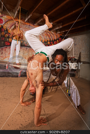 To use this stock image in your creative project, please select the size you need over to the right and click the "Add to Cart" button.
Your downloaded image will come with the Cutcaster watermark removed so don’t worry about the watermark you see on this page. Helping Capoeira Partner with Handstand stock photo, Capoeira expert working with partner in handstand by Scott Griessel