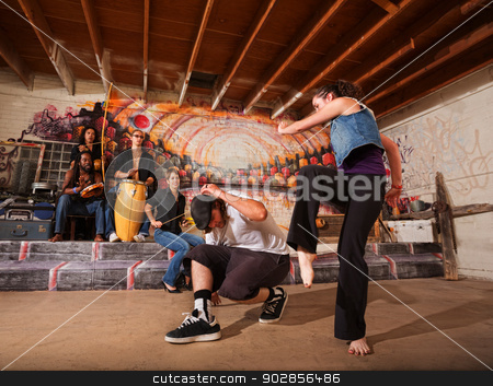 To use this stock image in your creative project, please select the size you need over to the right and click the "Add to Cart" button.
Your downloaded image will come with the Cutcaster watermark removed so don’t worry about the watermark you see on this page. Musicians and Capoeira Performers stock photo, Musicians playing during a capoeira performance indoors by Scott Griessel