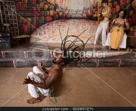 To use this stock image in your creative project, please select the size you need over to the right and click the "Add to Cart" button.
Your downloaded image will come with the Cutcaster watermark removed so don’t worry about the watermark you see on this page. Group of Capoeira Performers stock photo, Group of capoeira performers in action and playing music by Scott Griessel
