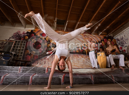 To use this stock image in your creative project, please select the size you need over to the right and click the "Add to Cart" button.
Your downloaded image will come with the Cutcaster watermark removed so don’t worry about the watermark you see on this page. Woman in Split Handstand stock photo, Female capoeira expert performing handstand splits by Scott Griessel