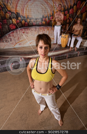 To use this stock image in your creative project, please select the size you need over to the right and click the "Add to Cart" button.
Your downloaded image will come with the Cutcaster watermark removed so don’t worry about the watermark you see on this page. Confident Capoeira Performer stock photo, Fit young woman posing with capoeira performers indoors by Scott Griessel