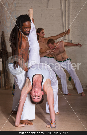 To use this stock image in your creative project, please select the size you need over to the right and click the "Add to Cart" button.
Your downloaded image will come with the Cutcaster watermark removed so don’t worry about the watermark you see on this page. Capoeira Holding Student Backward stock photo, Capoeira instructor holding student that is bending backwards by Scott Griessel