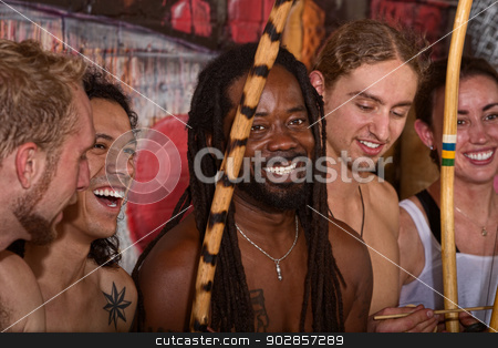 To use this stock image in your creative project, please select the size you need over to the right and click the "Add to Cart" button.
Your downloaded image will come with the Cutcaster watermark removed so don’t worry about the watermark you see on this page. Happy Capoeira Group stock photo, Handsome Brazilian man with group of capoeira performers by Scott Griessel