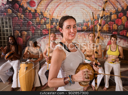 To use this stock image in your creative project, please select the size you need over to the right and click the "Add to Cart" button.
Your downloaded image will come with the Cutcaster watermark removed so don’t worry about the watermark you see on this page. Happy Capoeira Musician stock photo, Young group of capoeira musicians in urban building by Scott Griessel
