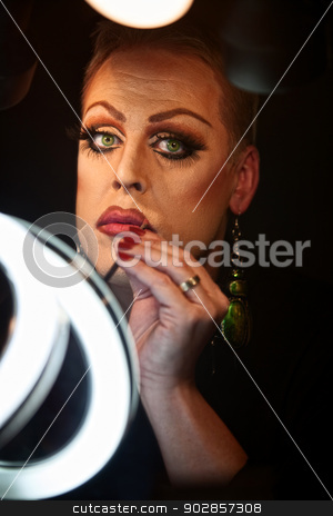 To use this stock image in your creative project, please select the size you need over to the right and click the "Add to Cart" button.
Your downloaded image will come with the Cutcaster watermark removed so don’t worry about the watermark you see on this page. Drag Queen Using Lipstick stock photo, Serious Caucasian drag queen using lipstick by Scott Griessel