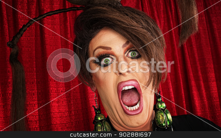 To use this stock image in your creative project, please select the size you need over to the right and click the "Add to Cart" button.
Your downloaded image will come with the Cutcaster watermark removed so don’t worry about the watermark you see on this page. Screaming Man in Drag stock photo, Screaming man in drag over red curtain by Scott Griessel