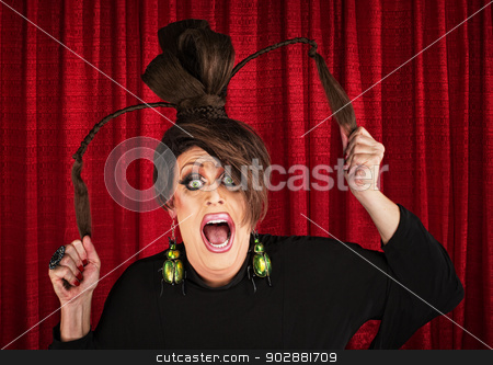 To use this stock image in your creative project, please select the size you need over to the right and click the "Add to Cart" button.
Your downloaded image will come with the Cutcaster watermark removed so don’t worry about the watermark you see on this page. Screaming Drag Queen Pulling Hair stock photo, Desperate white drag queen over curtain pulling ponytails by Scott Griessel