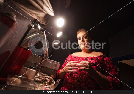 To use this stock image in your creative project, please select the size you need over to the right and click the "Add to Cart" button.
Your downloaded image will come with the Cutcaster watermark removed so don’t worry about the watermark you see on this page. Man Dressing as a Woman stock photo, Man in backstage dressing up as a woman by Scott Griessel