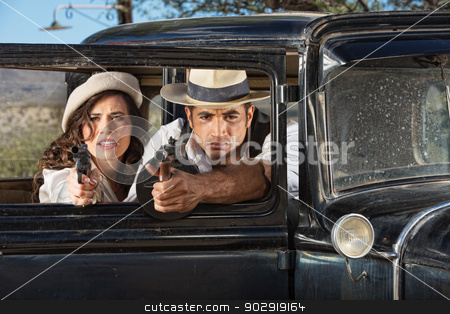 To use this stock image in your creative project, please select the size you need over to the right and click the "Add to Cart" button.
Your downloaded image will come with the Cutcaster watermark removed so don’t worry about the watermark you see on this page. 1920s Male and Female Gangsters stock photo, 1920s vintage gangsters firing guns from car window by Scott Griessel