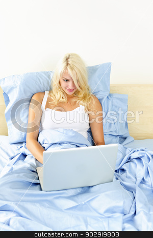 To use this stock image in your creative project, please select the size you need over to the right and click the "Add to Cart" button.
Your downloaded image will come with the Cutcaster watermark removed so don’t worry about the watermark you see on this page. Woman sitting in bed with computer stock photo, Happy blonde woman using computer sitting in bed by Elena Elisseeva