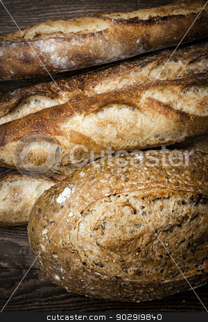 To use this stock image in your creative project, please select the size you need over to the right and click the "Add to Cart" button.
Your downloaded image will come with the Cutcaster watermark removed so don’t worry about the watermark you see on this page. Artisan bread stock photo, Fresh baked rustic bread loaves on dark wood background by Elena Elisseeva
