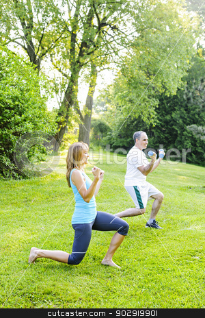 To use this stock image in your creative project, please select the size you need over to the right and click the "Add to Cart" button.
Your downloaded image will come with the Cutcaster watermark removed so don’t worry about the watermark you see on this page. Personal trainer with client exercising outside stock photo, Female fitness instructor exercising with middle aged man outdoors in green park by Elena Elisseeva