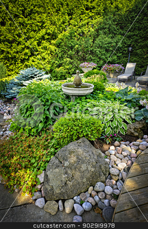 To use this stock image in your creative project, please select the size you need over to the right and click the "Add to Cart" button.
Your downloaded image will come with the Cutcaster watermark removed so don’t worry about the watermark you see on this page. Lush landscaped garden stock photo, Lush perennial garden with fountain plants and trees by Elena Elisseeva