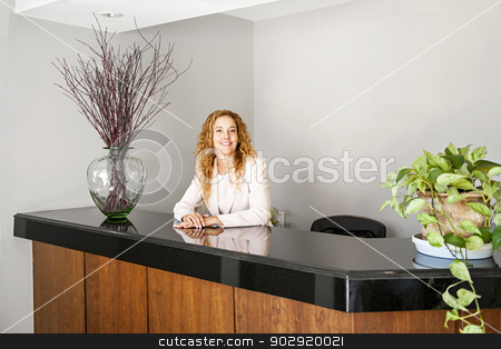 To use this stock image in your creative project, please select the size you need over to the right and click the "Add to Cart" button.
Your downloaded image will come with the Cutcaster watermark removed so don’t worry about the watermark you see on this page. Smiling woman at office reception stock photo, Receptionist standing at reception counter in office by Elena Elisseeva