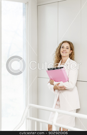 To use this stock image in your creative project, please select the size you need over to the right and click the "Add to Cart" button.
Your downloaded image will come with the Cutcaster watermark removed so don’t worry about the watermark you see on this page. Smiling businesswoman standing in hallway stock photo, Happy confident business woman standing in office hallway holding binder by Elena Elisseeva