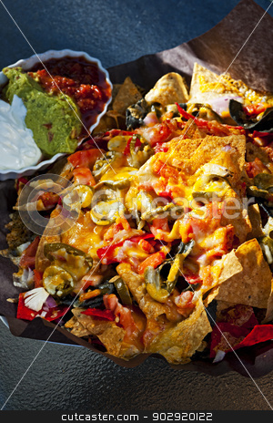 To use this stock image in your creative project, please select the size you need over to the right and click the "Add to Cart" button.
Your downloaded image will come with the Cutcaster watermark removed so don’t worry about the watermark you see on this page. Nacho basket with cheese stock photo, Basket of nachos with cheese jalapeno and toppings by Elena Elisseeva