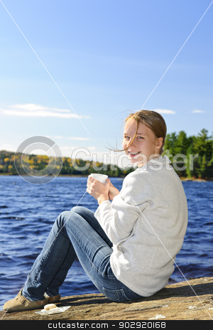 To use this stock image in your creative project, please select the size you need over to the right and click the "Add to Cart" button.
Your downloaded image will come with the Cutcaster watermark removed so don’t worry about the watermark you see on this page. Young woman relaxing at lake shore stock photo, Young woman sitting with beverage on rock relaxing by beautiful lake in Algonquin Park, Canada by Elena Elisseeva