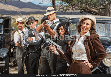 To use this stock image in your creative project, please select the size you need over to the right and click the "Add to Cart" button.
Your downloaded image will come with the Cutcaster watermark removed so don’t worry about the watermark you see on this page. Laughing 1920s Era Gangsters stock photo, Laughing beautiful woman with submachine gun and gangsters by Scott Griessel