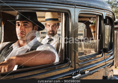 To use this stock image in your creative project, please select the size you need over to the right and click the "Add to Cart" button.
Your downloaded image will come with the Cutcaster watermark removed so don’t worry about the watermark you see on this page. Watchful Pair of 1920s Gangsters stock photo, Pair of 1920s gangsters watching from a car by Scott Griessel