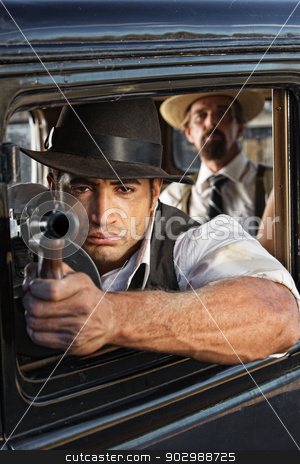 To use this stock image in your creative project, please select the size you need over to the right and click the "Add to Cart" button.
Your downloaded image will come with the Cutcaster watermark removed so don’t worry about the watermark you see on this page. Muscular Gangster Shooting Gun stock photo, 1920s vintage gangsters shooting submachine gun from car by Scott Griessel