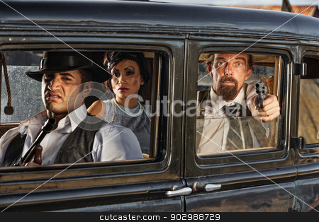 To use this stock image in your creative project, please select the size you need over to the right and click the "Add to Cart" button.
Your downloaded image will come with the Cutcaster watermark removed so don’t worry about the watermark you see on this page. 1920s Era Gangsters Drive By stock photo, Group of 1920s vintage gangsters in drive by shooting by Scott Griessel
