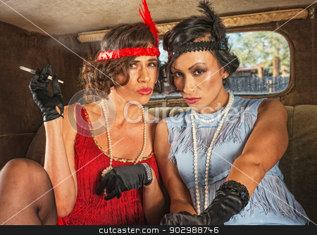 To use this stock image in your creative project, please select the size you need over to the right and click the "Add to Cart" button.
Your downloaded image will come with the Cutcaster watermark removed so don’t worry about the watermark you see on this page. Retro Smoking Ladies in Car stock photo, Pair of retro women smoking inside antique car by Scott Griessel