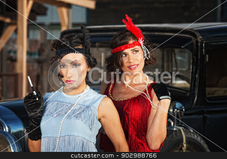 To use this stock image in your creative project, please select the size you need over to the right and click the "Add to Cart" button.
Your downloaded image will come with the Cutcaster watermark removed so don’t worry about the watermark you see on this page. Pretty Flapper Girls stock photo, 1920s flapper girls with cigarette near vintage automobile by Scott Griessel