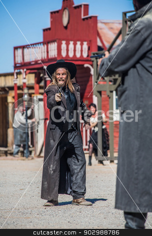 To use this stock image in your creative project, please select the size you need over to the right and click the "Add to Cart" button.
Your downloaded image will come with the Cutcaster watermark removed so don’t worry about the watermark you see on this page. Bandit Yells at Sheriff in Duel stock photo, A Bandit Yells as he Draws His Gun on the Sheriff by Scott Griessel