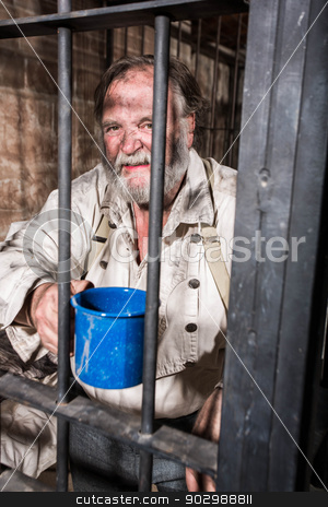 To use this stock image in your creative project, please select the size you need over to the right and click the "Add to Cart" button.
Your downloaded image will come with the Cutcaster watermark removed so don’t worry about the watermark you see on this page. Angry Old West Prisoner stock photo, Angry Man in an Old West Jail by Scott Griessel