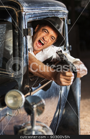 To use this stock image in your creative project, please select the size you need over to the right and click the "Add to Cart" button.
Your downloaded image will come with the Cutcaster watermark removed so don’t worry about the watermark you see on this page. 1920s Era Drive By Shooting stock photo, Yelling man firing submachine gun from vintage 1920s car by Scott Griessel