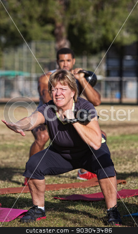 To use this stock image in your creative project, please select the size you need over to the right and click the "Add to Cart" button.
Your downloaded image will come with the Cutcaster watermark removed so don’t worry about the watermark you see on this page. Middle Aged Woman In Workout Class stock photo, Strong middle aged woman squatting with kettle bell weights by Scott Griessel