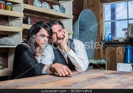 To use this stock image in your creative project, please select the size you need over to the right and click the "Add to Cart" button.
Your downloaded image will come with the Cutcaster watermark removed so don’t worry about the watermark you see on this page. Serious Western Sheriff and Woman Pose Inside House stock photo, Serious Looking Western Sheriff and Woman Pose Inside of a House by Scott Griessel