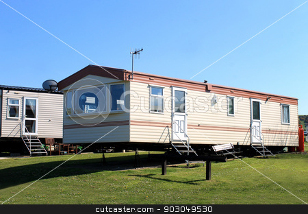 To use this stock image in your creative project, please select the size you need over to the right and click the "Add to Cart" button.
Your downloaded image will come with the Cutcaster watermark removed so don’t worry about the watermark you see on this page. Caravans in trailer park stock photo, Side view of modern caravans in trailer park, Scarborough, England. by Martin Crowdy