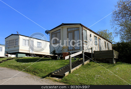 To use this stock image in your creative project, please select the size you need over to the right and click the "Add to Cart" button.
Your downloaded image will come with the Cutcaster watermark removed so don’t worry about the watermark you see on this page. modern caravans in trailer park stock photo, Low angle view of modern caravans in trailer park, Scarborough, England. by Martin Crowdy