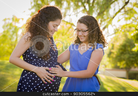 To use this stock image in your creative project, please select the size you need over to the right and click the "Add to Cart" button.
Your downloaded image will come with the Cutcaster watermark removed so don’t worry about the watermark you see on this page. Hispanic Daughter Feels Baby Kick in Pregnant Mother’s Tummy stock photo, Hispanic Daughter Feels Baby Kick in Pregnant Mother’s Tummy Outdoors At the Park. by Andy Dean