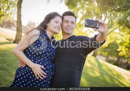 To use this stock image in your creative project, please select the size you need over to the right and click the "Add to Cart" button.
Your downloaded image will come with the Cutcaster watermark removed so don’t worry about the watermark you see on this page. Pregnant Wife and Husband Taking Cell Phone Picture of Themselve stock photo, Pregnant Wife and Husband Taking Cell Phone Picture of Themselves Outdoors At The Park. by Andy Dean