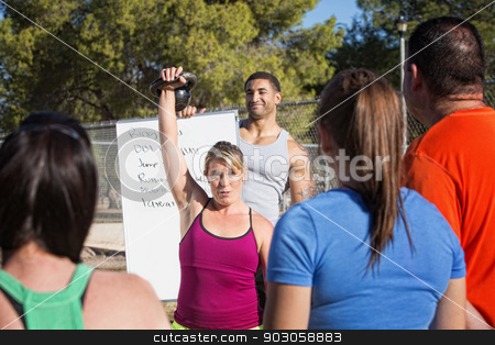 To use this stock image in your creative project, please select the size you need over to the right and click the "Add to Cart" button.
Your downloaded image will come with the Cutcaster watermark removed so don’t worry about the watermark you see on this page. Insructor Demonstrating Kettle Bell Lifting stock photo, Fitness instructors demonstrating how to lift kettle bell weights by Scott Griessel