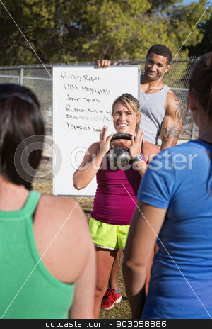 To use this stock image in your creative project, please select the size you need over to the right and click the "Add to Cart" button.
Your downloaded image will come with the Cutcaster watermark removed so don’t worry about the watermark you see on this page. Kettle Bell Weight Explanation stock photo, Smiling fitness instructors demonstrating weight lifting to a class by Scott Griessel