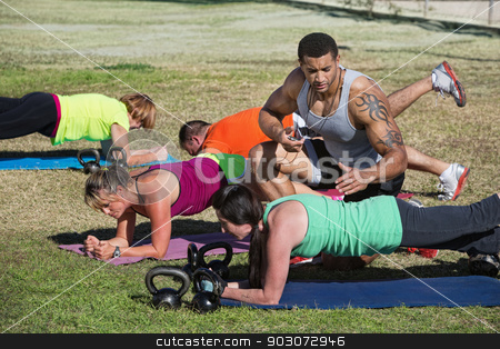 To use this stock image in your creative project, please select the size you need over to the right and click the "Add to Cart" button.
Your downloaded image will come with the Cutcaster watermark removed so don’t worry about the watermark you see on this page. Fitness Instructor Timing Students stock photo, Muscular instructor with stopwatch helping students in fitness class by Scott Griessel