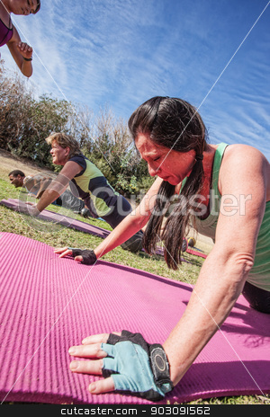 To use this stock image in your creative project, please select the size you need over to the right and click the "Add to Cart" button.
Your downloaded image will come with the Cutcaster watermark removed so don’t worry about the watermark you see on this page. People Doing Push-Ups stock photo, Boot camp fitness instructor timing class push-ups by Scott Griessel