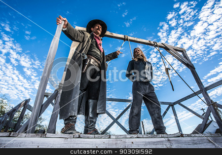To use this stock image in your creative project, please select the size you need over to the right and click the "Add to Cart" button.
Your downloaded image will come with the Cutcaster watermark removed so don’t worry about the watermark you see on this page. Western Man Awaits Execution stock photo, Western Man Awaits Execution of Being Hung From the Neck At Gallows by Scott Griessel