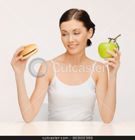 To use this stock image in your creative project, please select the size you need over to the right and click the "Add to Cart" button.
Your downloaded image will come with the Cutcaster watermark removed so don’t worry about the watermark you see on this page. woman with hamburger and apple stock photo, picture of beautiful woman with hamburger and apple by Syda Productions
