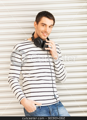 To use this stock image in your creative project, please select the size you need over to the right and click the "Add to Cart" button.
Your downloaded image will come with the Cutcaster watermark removed so don’t worry about the watermark you see on this page. handsome man with headphones stock photo, man in casual clothes with headphones leaning to wall by Syda Productions