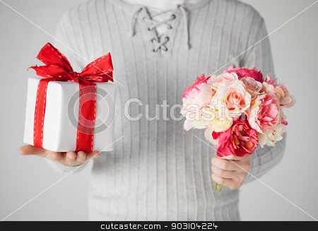 To use this stock image in your creative project, please select the size you need over to the right and click the "Add to Cart" button.
Your downloaded image will come with the Cutcaster watermark removed so don’t worry about the watermark you see on this page. man holding bouquet of flowers and gift box stock photo, close up of man holding bouquet of flowers and gift box. by Syda Productions
