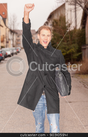 To use this stock image in your creative project, please select the size you need over to the right and click the "Add to Cart" button.
Your downloaded image will come with the Cutcaster watermark removed so don’t worry about the watermark you see on this page. Handsome successful urban man cheering stock photo, Handsome stylish successful urban man cheering as he walks down a street in town with a brief case under his arm and his arm raised in jubilation by Roland Stollner