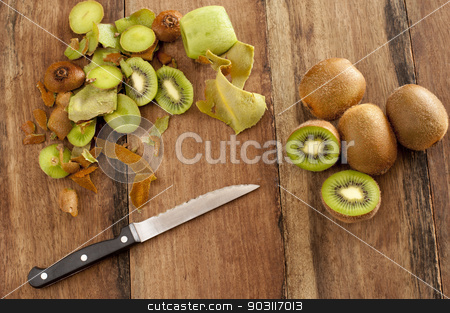 To use this stock image in your creative project, please select the size you need over to the right and click the "Add to Cart" button.
Your downloaded image will come with the Cutcaster watermark removed so don’t worry about the watermark you see on this page. Peeling and dicing kiwifruit for dessert stock photo, Overhead view of a wooden kitchen counter with a knife and fresh kiwi fruit that are being peeled and diced for a healthy delicious tropical dessert by Stephen Gibson