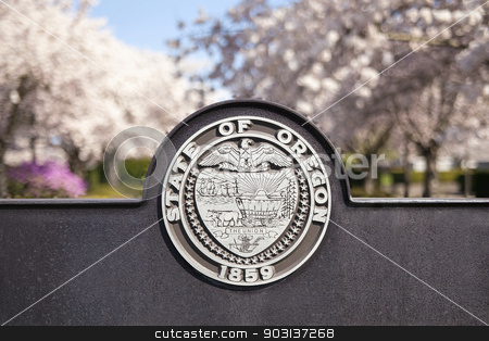 To use this stock image in your creative project, please select the size you need over to the right and click the "Add to Cart" button.
Your downloaded image will come with the Cutcaster watermark removed so don’t worry about the watermark you see on this page. Seal of the State of Oregon stock photo, SALEM, OREGON - MARCH 23, 2014: Seal of the State of Oregon Sign at Salem Oregon State Capitol State Park Closeup by Jit Lim