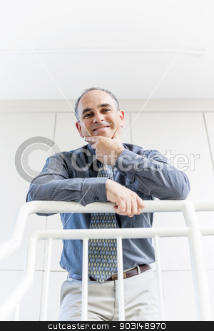 To use this stock image in your creative project, please select the size you need over to the right and click the "Add to Cart" button.
Your downloaded image will come with the Cutcaster watermark removed so don’t worry about the watermark you see on this page. Portrait of successful happy businessman in office stock photo, Smiling proud business man standing in office hallway leaning on railing shot from below by Elena Elisseeva